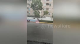 Sudden storm blows road barriers while ripping through streets in Manila, the Philippines