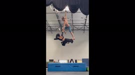 'Gifted aerial straps duo attempts a 'Neck Hang' during practice '