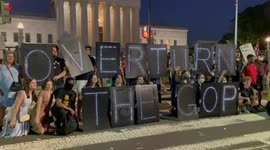Demonstrators spell “Overturn the GOP” in lights at Supreme Court