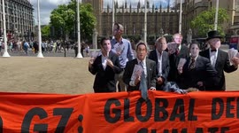 Climate activists dressed as G7 leaders in Parliament Square