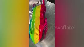 Street stall sells rainbow-coloured roasted pig in Thailand