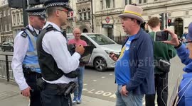 Activist confronts London police over new laws that restrict noisy protests