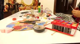 Palestinian artist Lana Awad, 24, paints on her face at her home in Gaza City