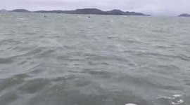 Two Burmese fishermen floating on plastic boxes rescued from sea after boat capsized