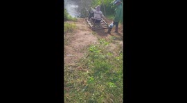 Locals use homemade cable cars to cross the flood water