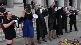 Climate justice protesters wear judicial robes outside federal courthouse in Manhattan in protest of Supreme Court decision on EPA authority