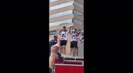 Colorado Avalanche players celebrate Stanley Cup victory with 'shoeys' during Denver parade