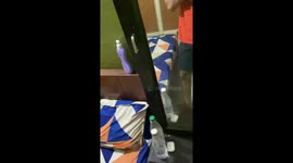 Spilling body lotion in mouth of sleeping Person