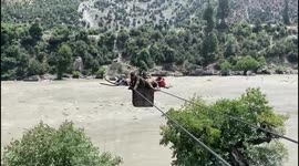 Soldiers use cable car raft to transport injured civilian over large river in Jammu and Kashmir