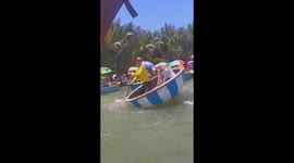 Visitors participate in the challenge of sitting on a basket boat that rotates in a circle for 1 minute