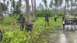 Philippine Marines escorts Muslim volunteers as they do road clearing and cleaning