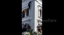 Demonstrator climbs Prime Minister’s Office in Sri Lankan capital demanding resignation