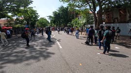An injuried Sri Lankan protester is carried away by fellow protesters