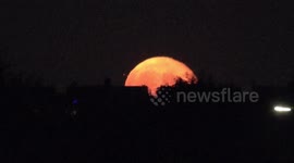 Plane That Looks Like A Red Bull Shoots Out Of The Buck Supermoon