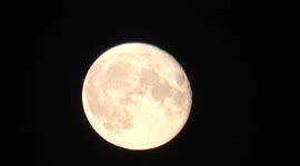 Footage Of A Plane Flying In Front Of The Buck Supermoon As Its Rises Over East London