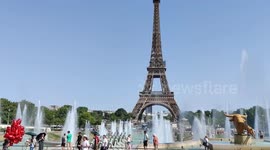 Tourists cool down in Paris' Trocadero fountain during heatwave