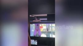 Pet shop sparks outrage with bikini-wearing models dancing in the FISH TANKS