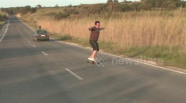 Guy skateboarding downhill ends with him faceplanting into roadside ditch