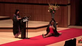 Watch as this student jumps into the splits during iconic graduation walk