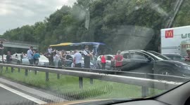 Brass band serenades stranded motorists on M6 motorway after a fire stopped traffic for hours