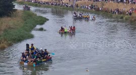Raft race sees competitors pelted with eggs as they paddle up river in Lewes Sussex UK