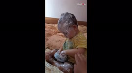 Toddler shows off his self-care skills by applying cream all over his body!