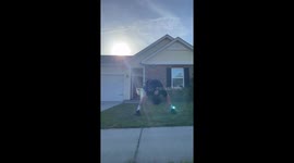 'Man perfectly catches a ball thrown over the house by his friend
'