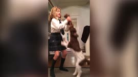 Girl Lifts Dog By Legs