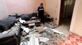 Palestinians inspect house left in ruins by Israeli air strike