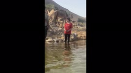 My daughter Salma with camel on Nile river , Aswan, Egypt