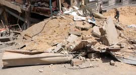 Palestinians inspect the ruins of a building destroyed by an Israeli air strike in Gaza