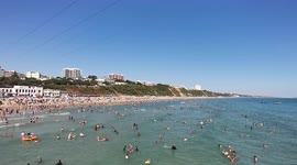 3_Packed Bournemouth beach with high zipwire fun flying over the sunbathers enjoying the hot weather