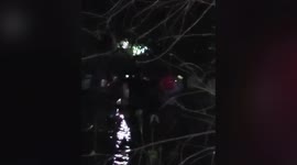 Fire brigade officials rescue five members of a family from car stuck in river in western India