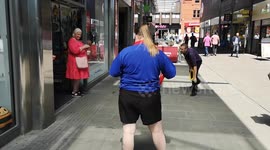 Shopworkers cool of in the scorching hot temperatures with a water pistol