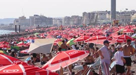 Huge crowds flock Brighton beach to take a dip in the refreshing sea as temperatures rise