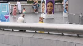 A comical scene in London as during the heatwave in a kid comes up with a great way to keep out the way of the sunshine by putting a paper bag on his head.
