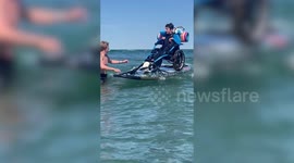 Teen with cerebral palsy learns to surf after friends strap his wheelchair to paddleboard