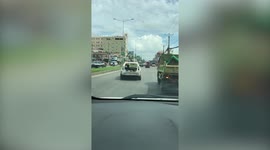 Bizarre moment motorist coasts along highway driving only his car's frame in Vietnam