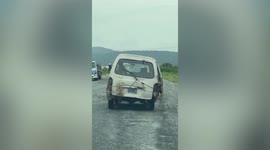 Beaten-up van on its last legs sputters along bumpy road in Cambodia