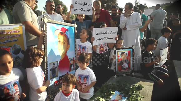 Palestinians demonstrate in front of children's graves as Israel claims responsibility for deadly raid