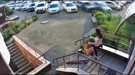 The girl fell with a stroller and a child while descending from the house