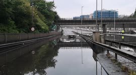 The A406 gets totally blocked by a huge flood caused by the downpour