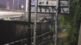 Teens tip toe fence to escape London flooding on A406 Motorway