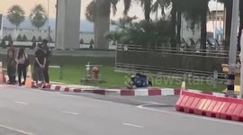 Bizarre moment passenger prostrates himself in front of king's portrait at Thai airport