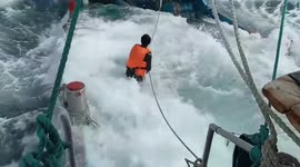 Fully loaded ship being weighed down by too many fish and smashed by big waves