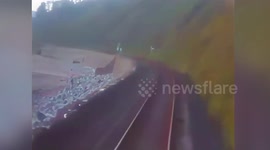 Shocking CCTV footage shows the moment a train missed a dog walker crossing the tracks