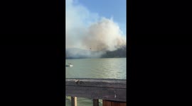 Fire-fighting chopper loads up with water to battle Point Fire in Lake County, California
