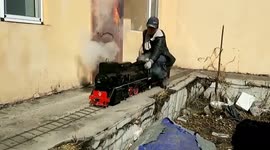 Chinese man builds miniature steam train that he can ride