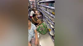 Elderly Chinese people rest in supermarket to escape heatwave