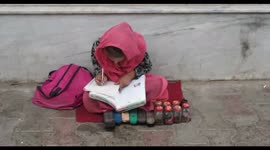 Afghan Girl Studying on the Streets of Kabul, Afghanistan